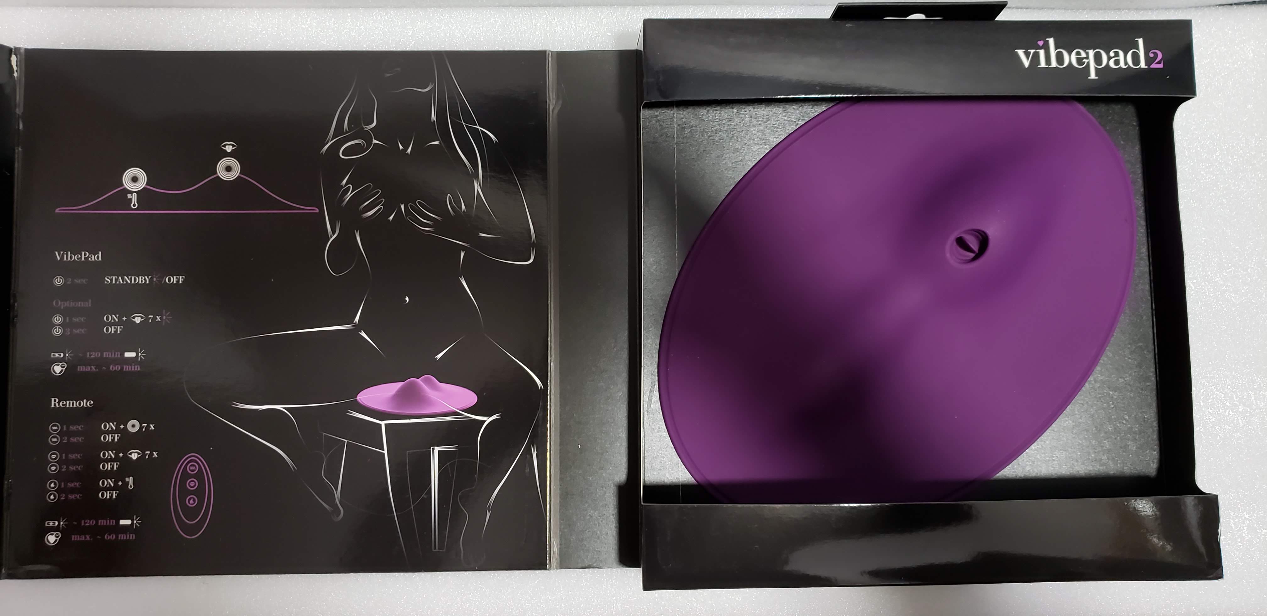 Image of Orion VibePad 2 in box with front flap open. Inside image shows a lineart drawing of a nude woman using the device and product details.